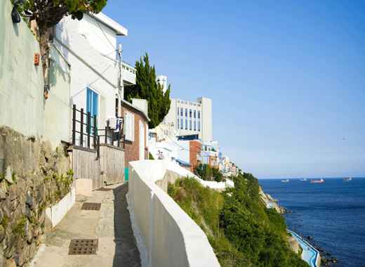 Coastal walkway near Best Western Haeundae Hotel in Busan overlooking the blue ocean.