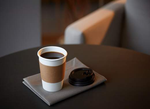 A warm cup of coffee on a table at Seoul Hotel Shilla Stay Seodaemun Seoul Station, cozy morning atmosphere in the hotel cafe.