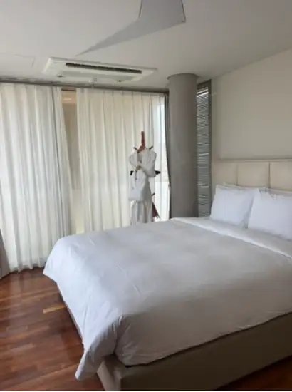 Modern bedroom interior at Bayhill Pool & Villa in Jeju with soft lighting and clean white bedding