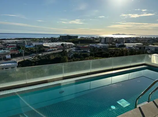 rivate pool with ocean view at Bayhill Pool & Villa in Jeju during a clear afternoon