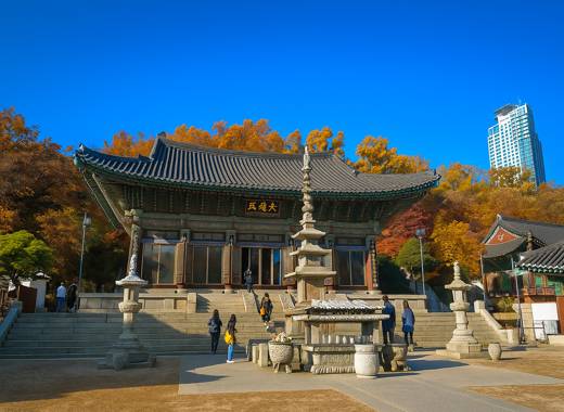 Bongeunsa Temple Daewoongjeon Hall in Seoul with bright blue sky and autumn trees during Seoul trip