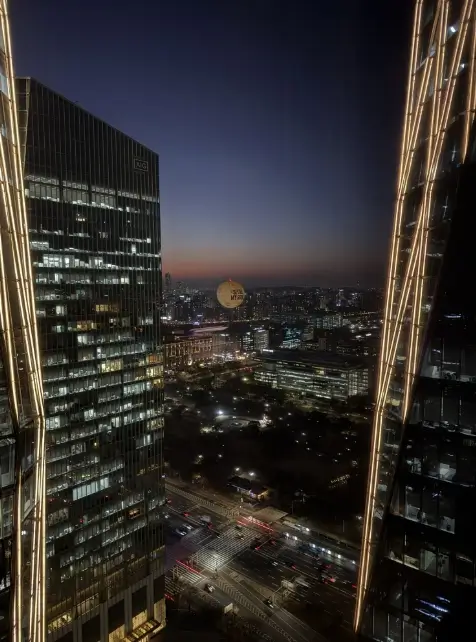 Night cityscape of Seoul viewed from a Conrad Seoul hotel room overlooking illuminated buildings and traffic