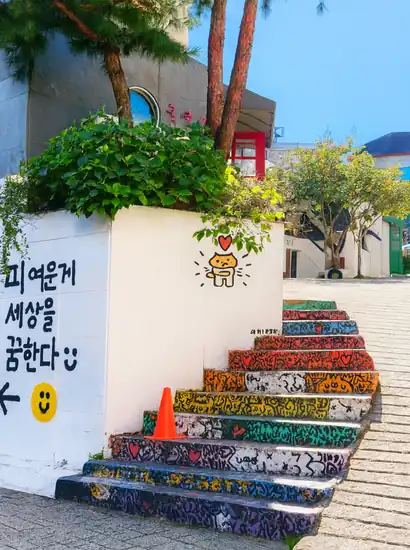 Haebangchon food guide colorful mural stairs in Seoul, vibrant street scene for foreign travelers