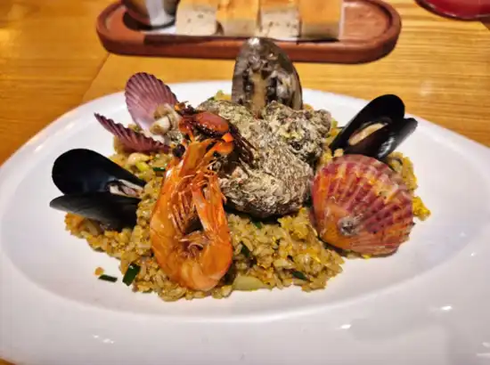 Seafood fried rice served with shrimp, mussels, and shellfish at a restaurant near Hallasan Dullegil Route 2 Doloreum Trail in Jeju.