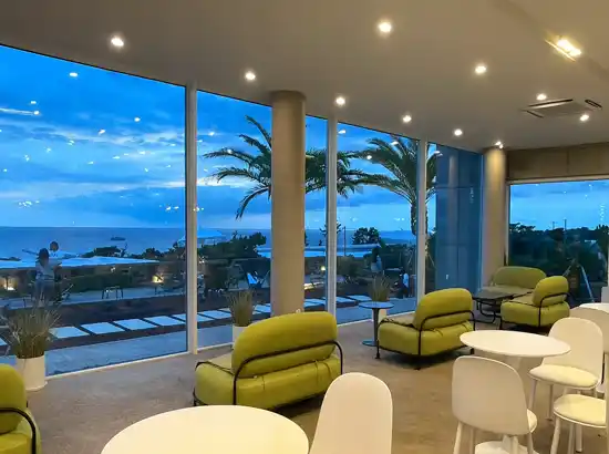 Modern café interior with ocean views, used during a visit to the Hallasan Dullegil Section 3 Forest Healing Trail itinerary.