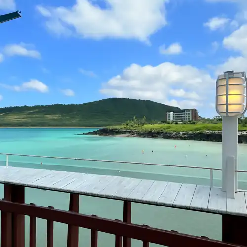 A clear ocean view near Hamdeok Beach, seen from a wooden deck during the Jeju Sangumburi Travel Course itinerary.
