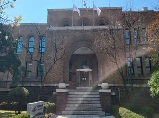 Historic Artist’s House building near Marronnier Park Seoul, with brick façade, arched entrance, and winter sunlight across the front.