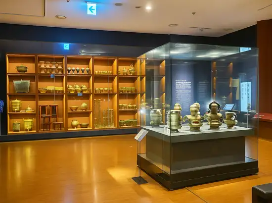 Royal artifacts gallery at the National Palace Museum of Korea featuring traditional brassware and court objects.

