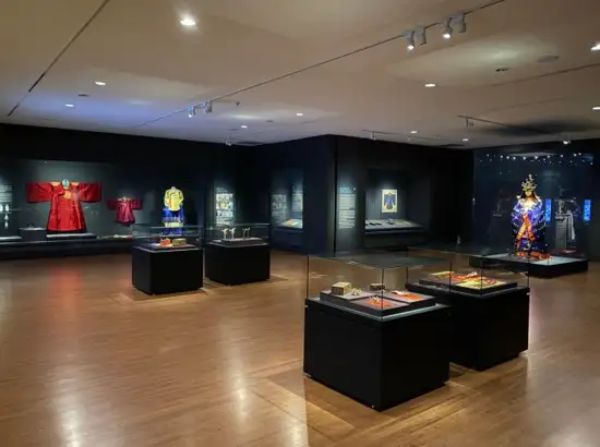 Exhibition hall at the National Palace Museum of Korea displaying royal garments and artifacts.
