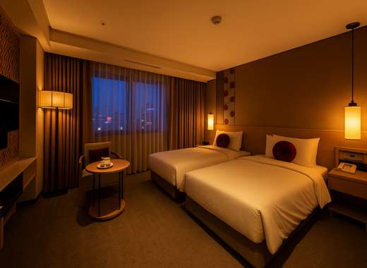 Royal Hotel Seoul twin room interior with white bed covers and warm lighting