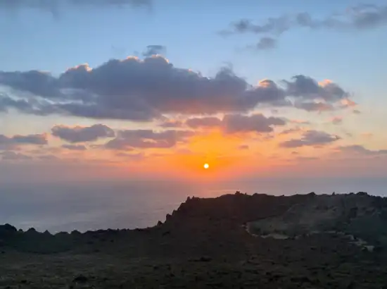 Bright morning sunrise viewed during a Seongsan Ilchulbong sunrise trip, with soft clouds and warm light over Jeju’s eastern coastline.