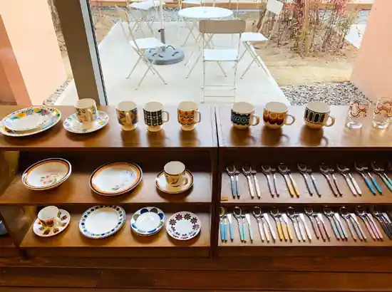 Tableware and colorful cutlery displayed in a Seongsu shop with an outdoor terrace view — Seongsu travel experience.