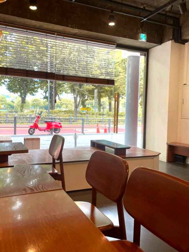 Warm and cozy interior of Bright Size Cafe near Seonyudo Park with autumn trees outside