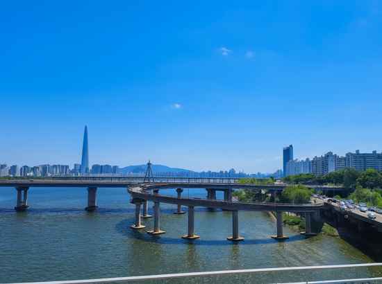 Han River view with city skyline and bridges along the Seoul Dulle-gil Course 6 Goduk Mountain trail.