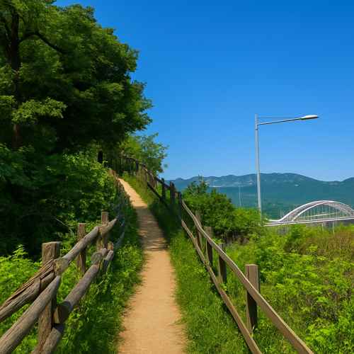 Scenic trail on Seoul Dulle-gil Course 6 Goduk Mountain surrounded by greenery and distant mountain views.