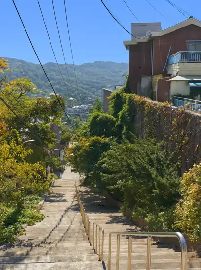 Downhill residential path with mountain scenery on the Seoul Trail 18 Course