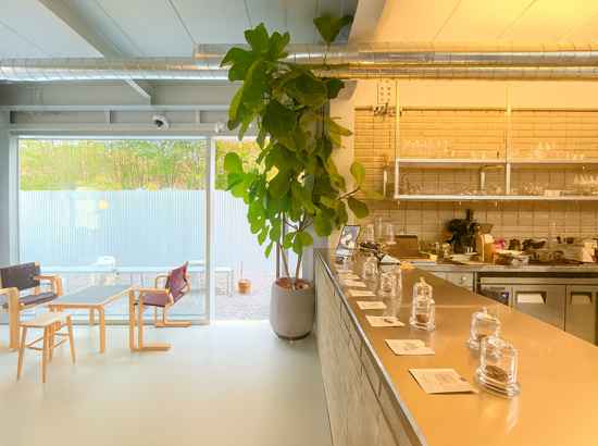 Bright and cozy cafe interior near Seoul Trail Course 8 Jangji-Tancheon, with seating, plants, and warm lighting.
