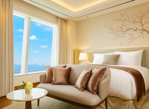 Bright and elegant Signiel Seoul hotel room with ivory curtains, a blue sky view through the window, and soft natural lighting