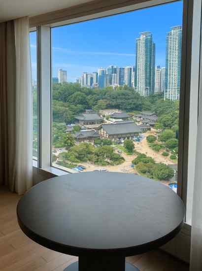 Room view from The Westin Seoul Parnas booking, overlooking Bongeunsa Temple and the Gangnam skyline in Seoul.