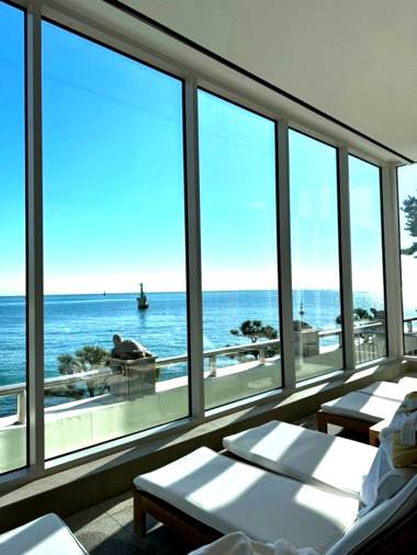 Indoor pool lounge at The Westin Chosun Busan with ocean view through large windows
