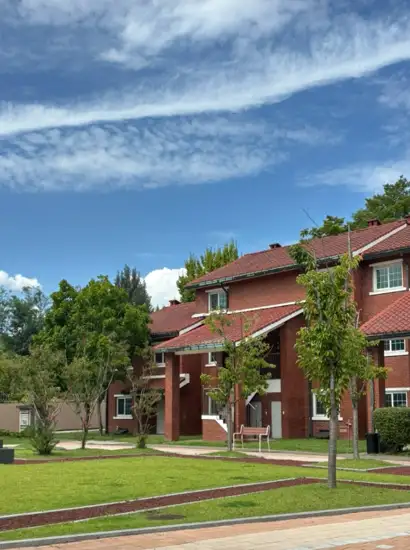 Red-brick building and green lawn at Yongsan Family Park under a bright blue sky in Seoul
