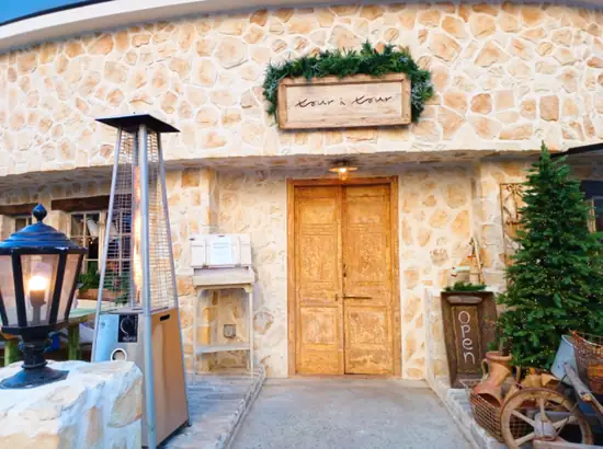Exterior of Tour à Tour bakery near Apgujeong Rodeo Street with a stone facade and wooden door