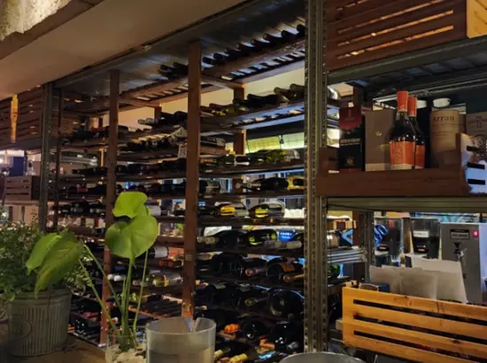 Cozy wine bar interior with stacked bottle shelves near Apgujeong Rodeo Street