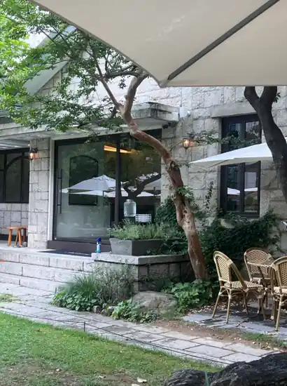 ddp cafe and tea garden terrace with outdoor umbrellas and stone-wall seating near Dongdaemun
