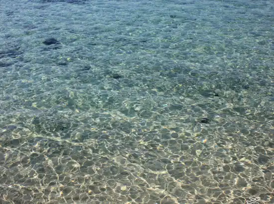 Crystal-clear shallow water at Jeju Hamdeok Beach, photographed for the Jeju Hamdeok Beach Travel Guide.