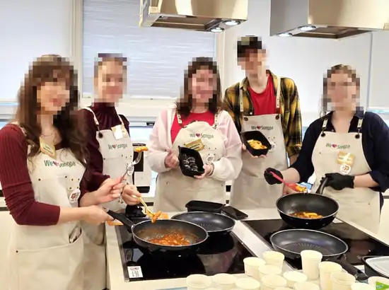 Group participants enjoying a hands-on K-Food Cooking Class Seoul at a Korean cooking studio