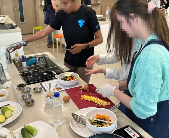 Hands-on K-Food Cooking Class Seoul with foreign participants preparing Korean dishes
