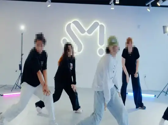 Participants practicing choreography during a K-POP Dance Class Seoul session at SM Universe, learning moves in a professional K-pop studio environment.