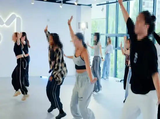 Participants practicing choreography during a K-POP Dance Class Seoul session at SM Universe, learning energetic moves in a professional K-pop studio.