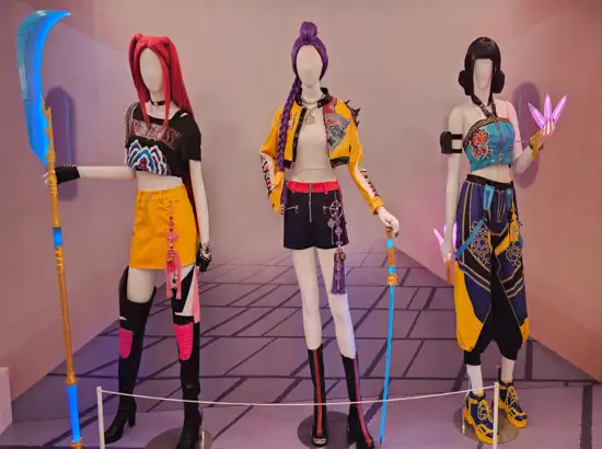 K-Pop Demon Hunters Pop-Up Store costume display featuring three mannequins wearing character outfits from the themed experience zone in Seoul