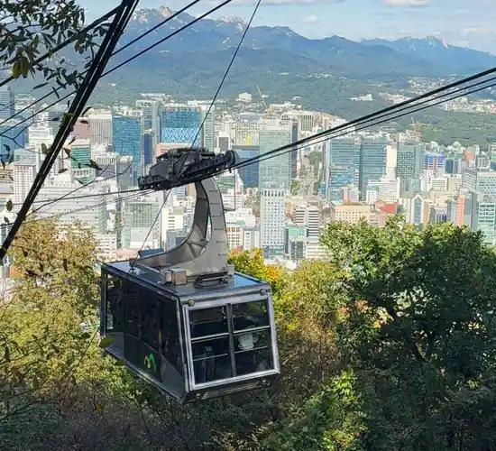 Namsan cable car gondola with Seoul skyline view on the way to N Seoul Tower, helpful for n seoul tower tickets planning