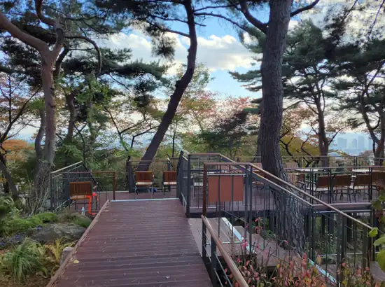 Scenic view deck with seating and city skyline glimpses on the namsan sky forest trail itinerary in Namsan, Seoul