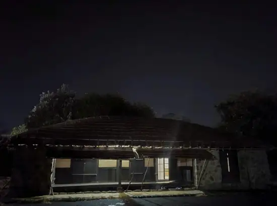 Night view of Seongeup Village Traditional House with traditional thatched roof and stone walls in Jeju