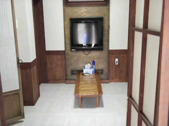 Interior room setup inside Seongeup Village Traditional House with traditional wooden furniture in Jeju