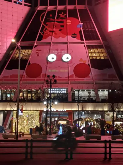 Christmas illumination at Seoul Light DDP building front with festive decorations and night lights at Dongdaemun Design Plaza.
