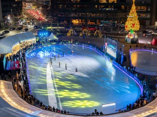 Seoul Plaza Ice Rink night view with people skating under colorful lights during winter season in downtown Seoul