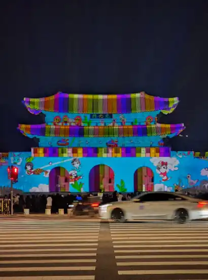 Media facade show projected onto Gwanghwamun Gate during the Seoul Winter Festa, featuring colorful animated graphics at night.