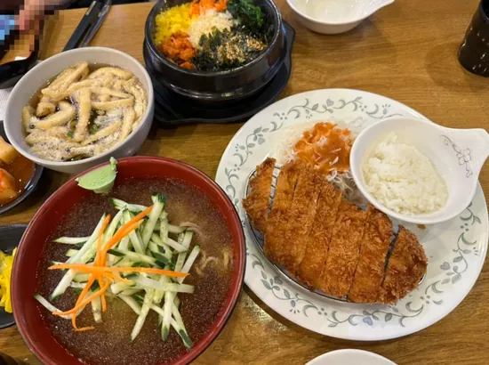 Donkatsu with cold soba noodles and an albap set served on a table at Apgujeong Haru