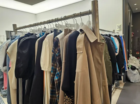 Dongdaemun wholesale market beginner guide: clothing rack with coats and tops inside a Dongdaemun night wholesale showroom in Seoul, Korea