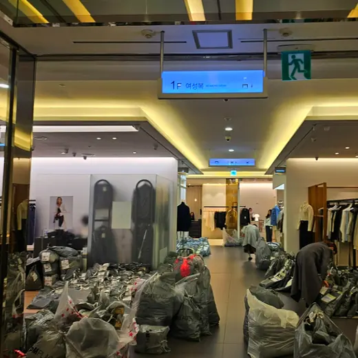 Dongdaemun wholesale market beginner guide: night wholesale building hallway with clothing racks and packed shipment bags in Seoul, Korea