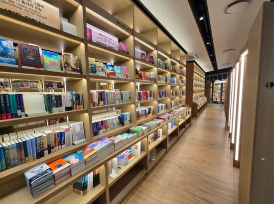 Quiet bookstore corridor with illuminated wooden shelves inside Yongsan iPark Mall