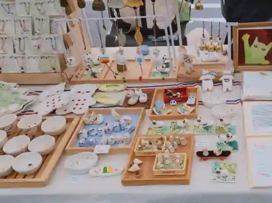 Handmade ceramics and small cat-themed crafts displayed on a market stall table in Itaewon, Seoul