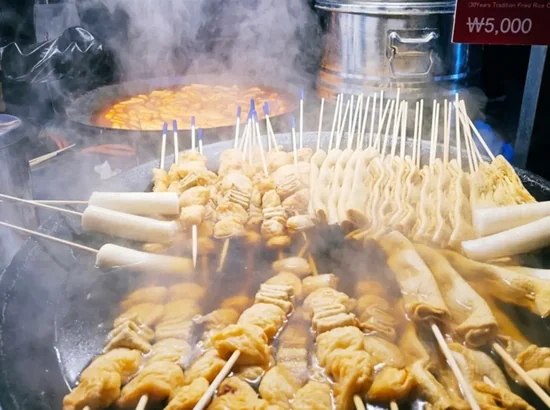 Steaming odeng (fish cake skewers) at a street food stall in Myeongdong, Seoul