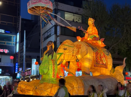 Buddha lantern sitting on an elephant during the 2026 Yeondeunghoe parade, with crowds joining the lantern procession in Seoul.