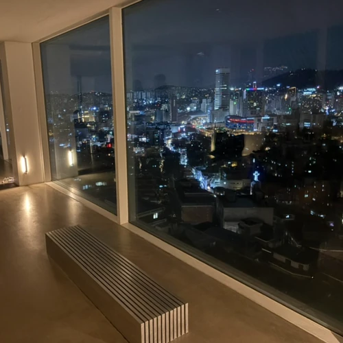Night city view from inside Tertre Cafe through large windows