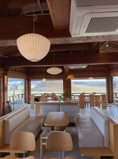 Interior view of Do Not Disturb Gyeongju branch with warm wooden seating and wide field view